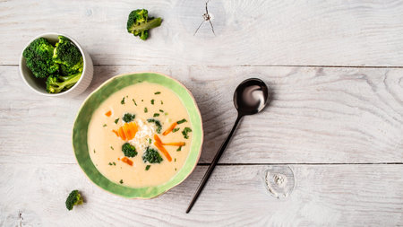 Traditional recipe of broccoli cheese soup with vegetables in a bowl with toast, homemade healthy organic vegetarian vegan diet fresh food meal dish soup lunch, space for text. top view.の写真素材