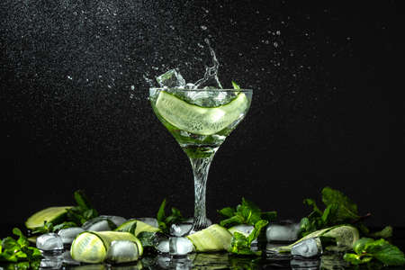 Gin-tonic alcoholic cocktail. liquor, ice. Freeze motion, drops in liquid splashの写真素材