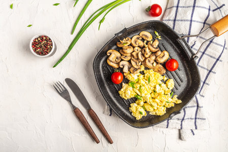 homemade, healthy breakfast scrambled eggs with mushrooms and cottage cheese in pan. banner, menu recipe place for text, top view.の写真素材