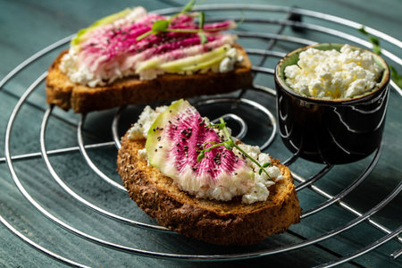 toasts from sliced watermelon radish with chinese daikon, cottage cheese and microgreen. Food recipe...