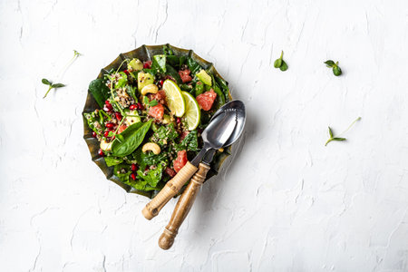 Trendy food - avocado salad with quinoa, spinach, grapefruit, pomegranate, nuts and microgreens. vegetarian recipe. healthy lunch dish. banner, catering menu recipe place for text, top view.の写真素材