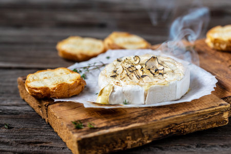 Hot baked or fried grilled Camembert or brie cheese with berry sauce or jam. Gourmet Traditional Breakfast. European cuisine.の写真素材