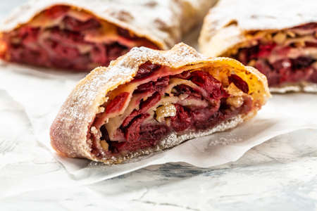 cherry strudel with walnut, Traditional Austrian cuisine, close up. white backgroundの写真素材