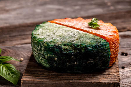 Cheese collection, piece of Spanish manchego cheese with red paprika, craft cheese green pesto cheese Pesto Rosso. catering, banner, menu, recipe, place for textの写真素材