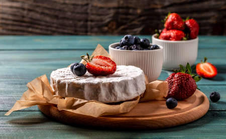 Fresh strawberries and brie cheese wooden board. banner menu recipe place for textの写真素材