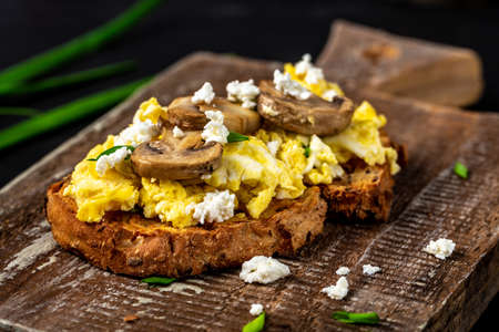 wholewheat toast with scrambled eggs with mushrooms and cottage cheese. healthy breakfast or brunch. Restaurant menu, dieting, cookbook recipe.の写真素材