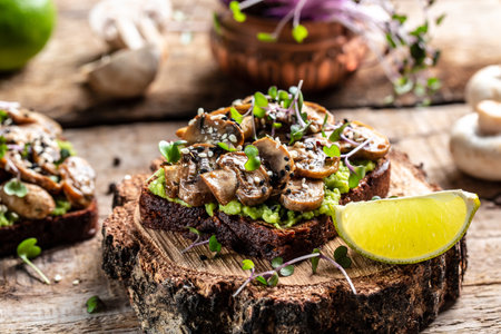 Bruschetta. Tasty sandwich Avocado, mushrooms. Healthy delicious breakfast or lunch. Vegan menu. Food recipe background. close up.の写真素材