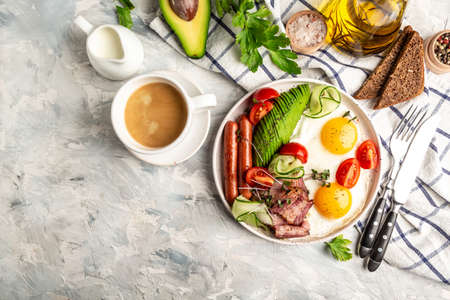 english breakfast table in a classic timeless cafe with fried eggs, sausages, beans, avocado and bacon, cup of fresh coffee, daily morning in London. catering, banner, menu, recipe, place for textの写真素材