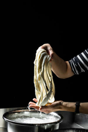 woman working in a small family creamery is processing the final steps of making a cheese, produces handmade mozzarella, silano or caciocavallo. close up. Copy space for text.の写真素材