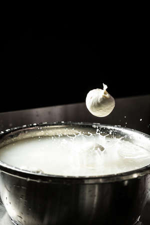Italian hard cheese silano or caciocavallo in cheesemaker hands. The homemade cheese maker produces...