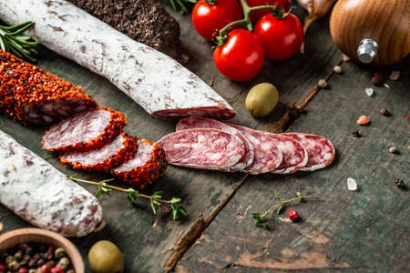 Spanish tapas sliced sausages salami, fuet and chorizo on a wooden background. Traditional Spanish sausage. banner, catering menu recipe place for text, top view.の写真素材