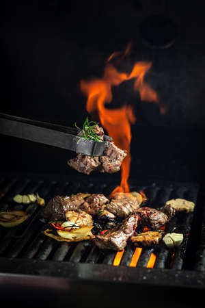 Beef steaks pieces of meat on the grill with flames. american cuisine. The concept cooking meat....