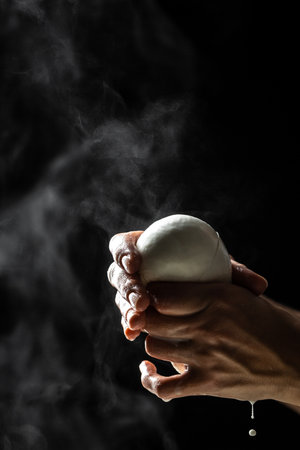 Cheesemaker showing the proceeding to make cheese from the bio milk. The homemade cheese maker produces caciocavallo. Pasta filata, Traditional Italian mozzarellaの写真素材