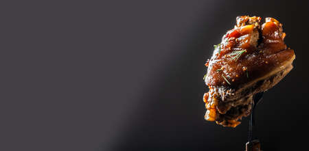 German cuisine, Roasted knuckle of pork with beer isolated on dark background, Bavarian grilled pork...