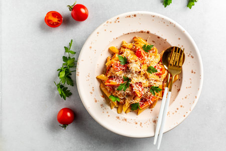 Pasta with cherry tomatoes, cheese and chicken meat on a light background. Pasta al Pomodoro. Italian food. Top viewの写真素材