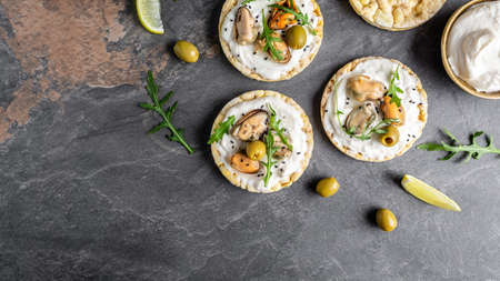 vegan sandwich with mussels, Crisp bread, soft cheese and arugula salad. Set of tasty appetizer...