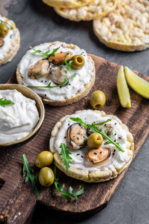 Bruschetta with mussels, cheese, crisp breads Mussels bruschetta, toast with soft cheese and...