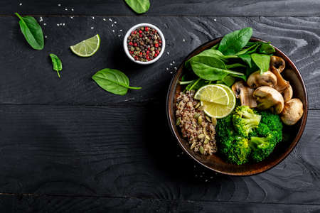 Diet salad made from fresh vegetables broccoli, mushrooms, spinach and quinoa in a bowl. Delicious...
