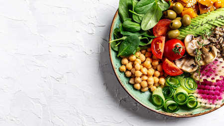 Buddha Bowl with Quinoa, Avocado, mushrooms cucumber, chickpeas, spinach, tomatoes vegetables salad....