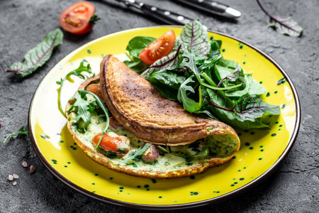 Omelette with cheese, tomatoes Frittata italian omelet on a yellow plate on a gray background. Keto, ketogenic lunch. Food recipe background. close up.の写真素材