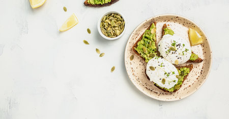 sandwich with avocado and poached egg. Healthy food concept. banner, menu recipe place for text, top view.の写真素材