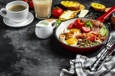 English breakfast in a cast iron frying pan fried egg, beans, tomatoes, mushrooms, bacon and toast. banner, menu, recipe, place for text. top view.の写真素材