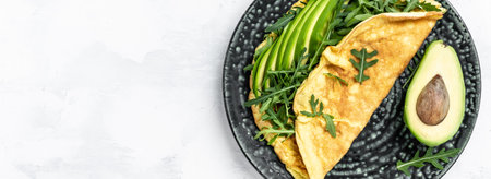 Frittata italian omelet with avocado and arugula. Delicious vegan, vegetarian breakfast, Long banner format, top view,の写真素材