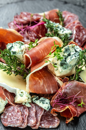 Antipasto with traditional Spanish meat snacks on a slate board, Antipasto platter. Food recipe background. close up.の写真素材