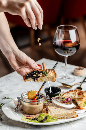 sandwich with meat pate and fruit jam. Putting pate on toast. Toasted bread with pate and jam. Delicious breakfast or snack on a light background, top view.の写真素材