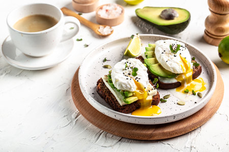 Sandwich with avocado and poached egg. Healthy nutritious paleo keto breakfast concept.の写真素材