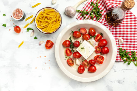 Trend Feta pasta recipe made of cherry tomatoes, feta cheese, garlic and herbs. cooking recipe ingredients, place for text, top view,の写真素材