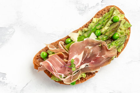 Tasty toast with avocado, asparagus and fried egg. Healthy food, diet lunch concept, top view.の写真素材