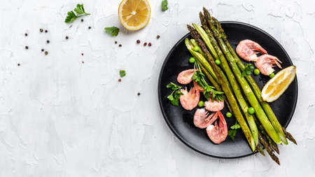 healthy eating salad baked asparagus with grilled shrimp, green peas and lemon. Keto breakfast. banner, menu recipe place for text, top view,の写真素材