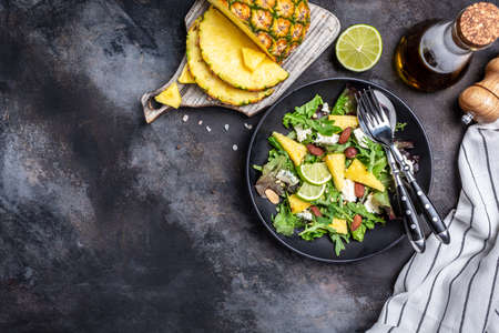 pineapple salad, summer salad with nuts, blue cheese and green rocket salad. banner, menu recipe place for text, top view.の写真素材