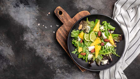 Diet menu. Healthy salad of fresh pineapple, blue cheese and almond. Vegan food. Long banner format, top view.の写真素材