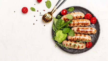 Barbecue sausage with spinach, avocado and cherry tomato. The ketogenic diet. Healthy fats, clean eating for weight loss. Keto paleo diet menu. top view.の写真素材