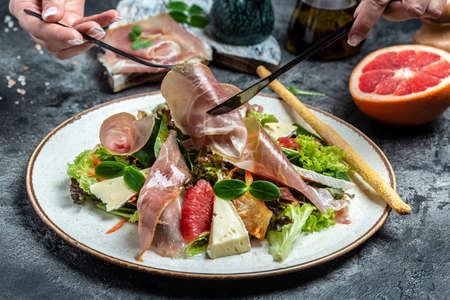 Prosciutto di Parma salad with grapefruit, salad mix, grapefruit, cherry tomatoes, parmesan cheese. cold snacks. Restaurant menu, dieting, cookbook recipe,の写真素材