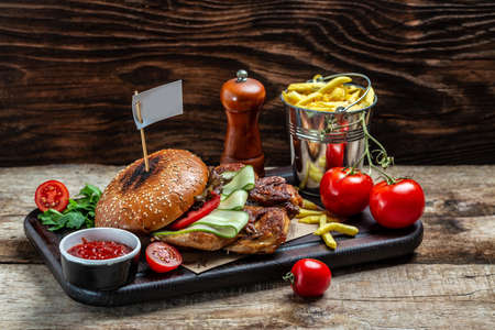 Big burger with chicken, Beer and Fries, patty burger with fries and dips meal. banner, menu, recipe place for text.の写真素材