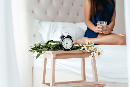 Alarm clock at the morning. Early wake up, not getting enough sleep, going work concept.の写真素材