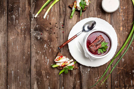 Borsch, soup, beet broth with vegetables and ribs, Traditional Ukrainian cuisine, wooden background. banner, menu, recipe place for text, top view,の写真素材