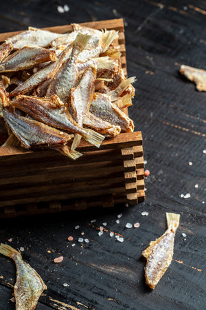 Sun fish dried, salted smelts on wooden background, Snack for beer dried smelts. banner, menu, recipe place for text. top view.の写真素材
