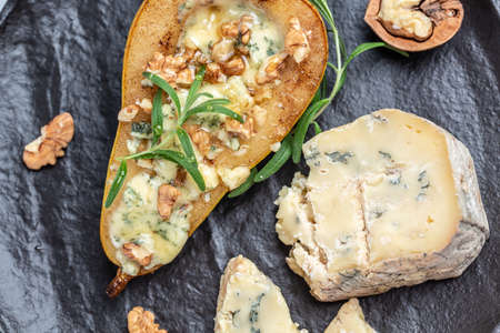 pear and cheese. pear baked with blue cheese, nuts and honey, Delicious balanced food concept. Food...