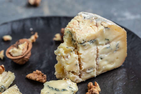 French blue cheese Roquefort, made from sheep milk with walnuts. Food recipe background. close up.