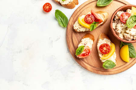 Homemade vegan sandwich with tomatoes, cream cheese and basil leaves. Healthy eating, diet tomato sandwich closeup.の写真素材