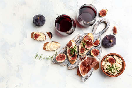 Appetizers. Sandwich with prosciutto, cream cheese and figs. antipasti with red wine. banner, menu...