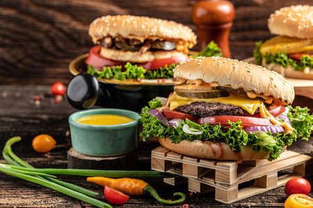 Craft beef burgers with vegetables on rustic wooden background. fast food and junk food concept,の写真素材