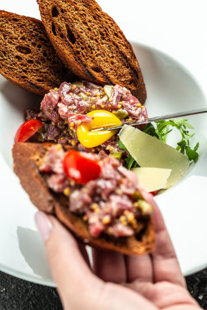 Tartare from beef with egg, and onions, fresh herbs, bread. french cuisine. Food recipe background. close up.の写真素材