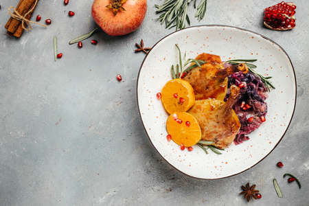 Christmas roast duck served with red cabbage on a festive table. Dish for Christmas Eve. banner,...