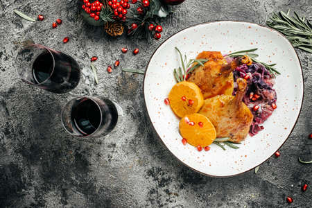 Delicious goose legs served with red cabbage on a festive table. Dish for Christmas Eve. banner, menu, recipe place for text, top view.の写真素材