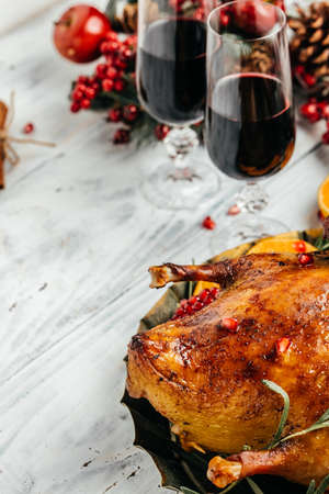 Baked Christmas duck with rosemary, berry and orange served on a festive table. vertical image. top view. place for text.の写真素材